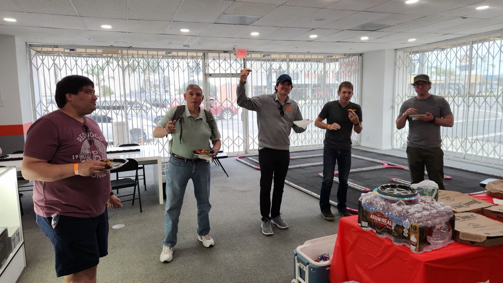 Young adults racing RC cars at a celebration