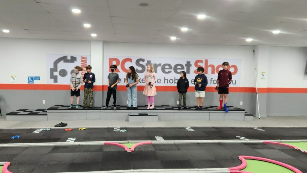 RC car birthday party setup with kids racing at indoor track in Los Angeles