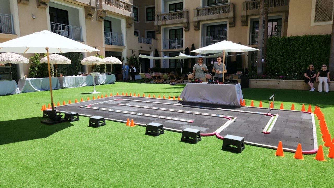 Portable RC race track set up outdoors on a lawn in Los Angeles