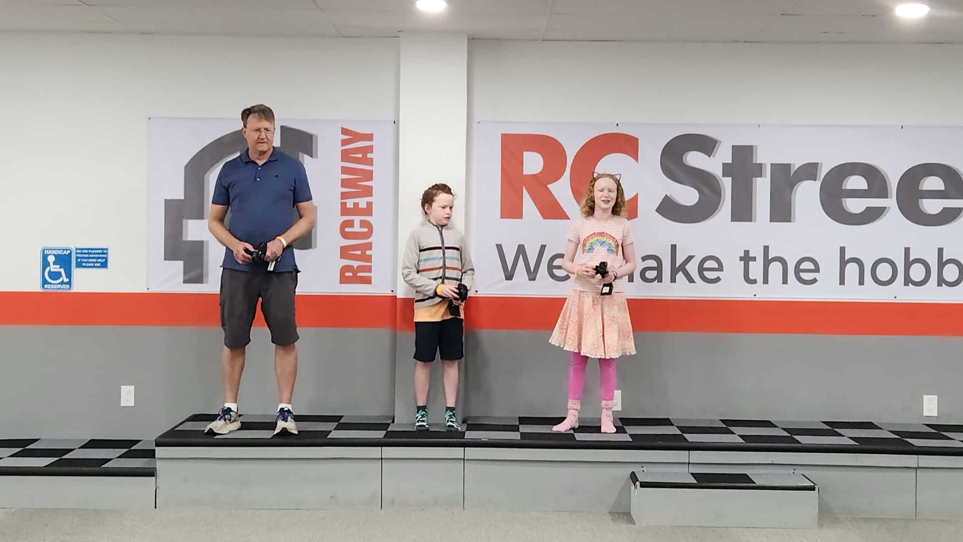 Family racing RC cars at an indoor birthday party in Lawndale, Los Angeles